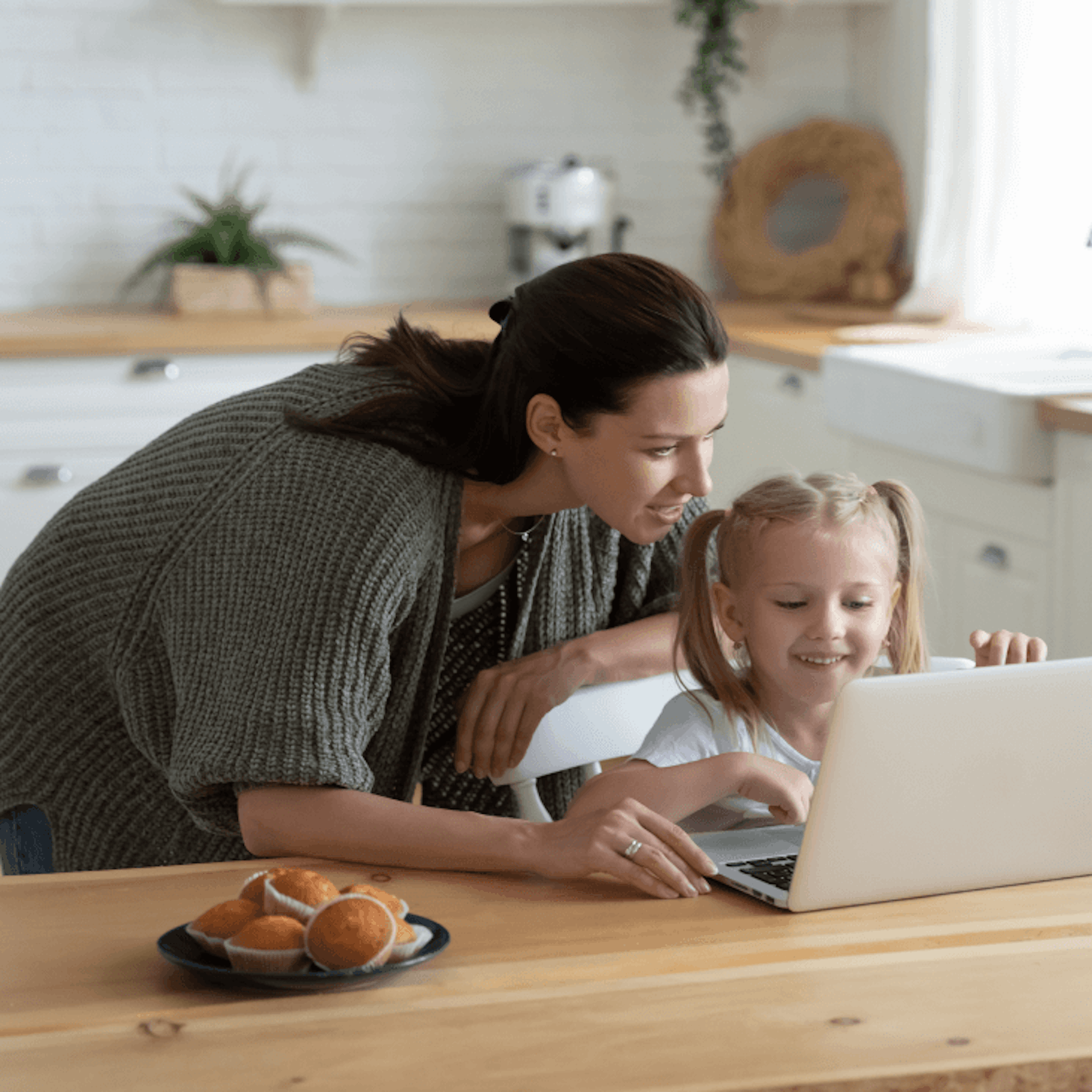 A mother helping her daughter with her studies.