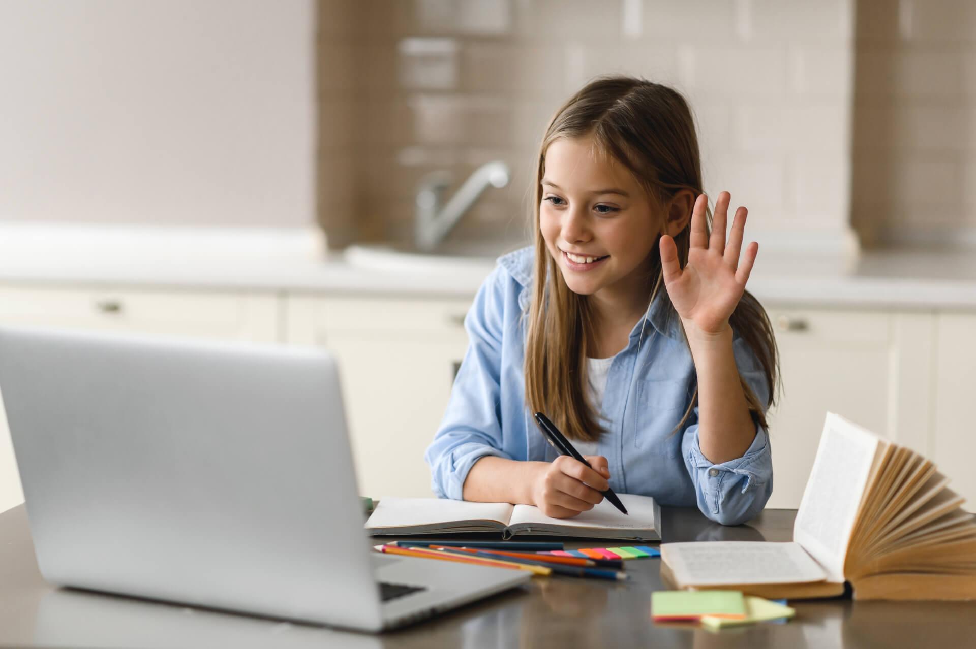 A girl raising her hand in an online class