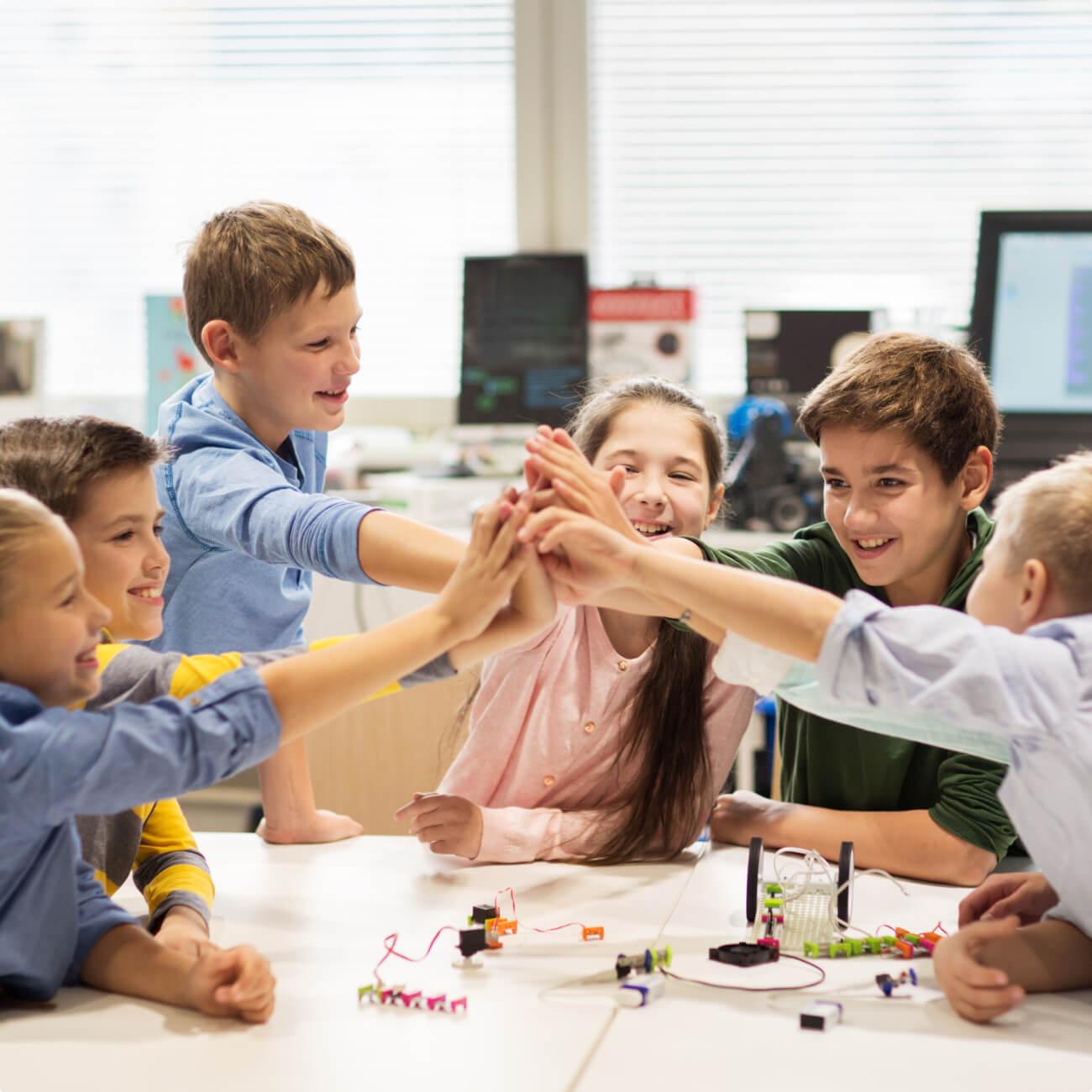 Six children high-fiving each other.